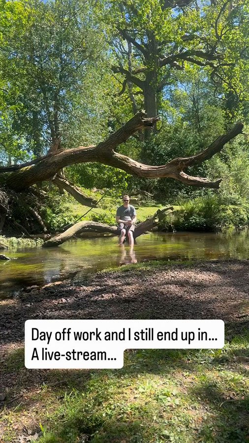 Feet dangling in the cold river on the Brockenhurst tall trees trail, shaded by forest canopy on a hot day