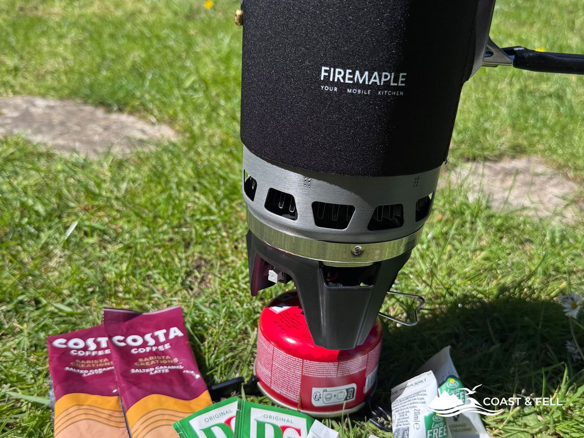 Fire Maple stove on gas canister with Costa coffee sachets on the grass
