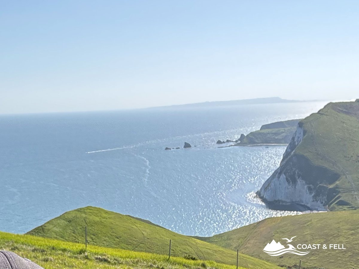 Shane selfie on clifftops with chalk cliffs and sea behind during Jurassic Coast Challenge