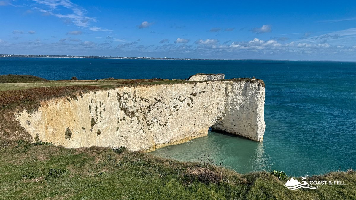The white chalk headland and arch at Old Harry Rocks, Handfast Point, with milky turquoise water at the cliff base