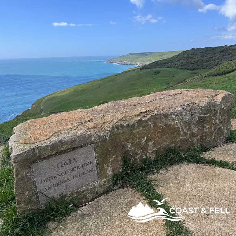 Memorial stone reading GAIA Distance nor time can break the bond, clifftop above Swanage, Dorset