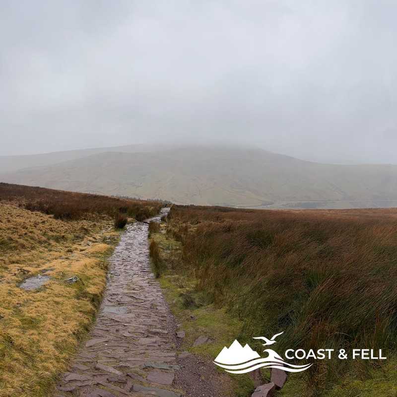 Flagstone path leading up to Pen-y-Fan with Corn Du in cloud, Brecon Beacons, Wales