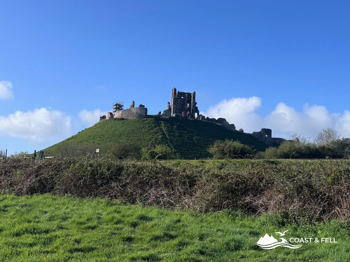 Corfe Castle ruins on a chalk mound in the Purbeck Hills, seen from the approach