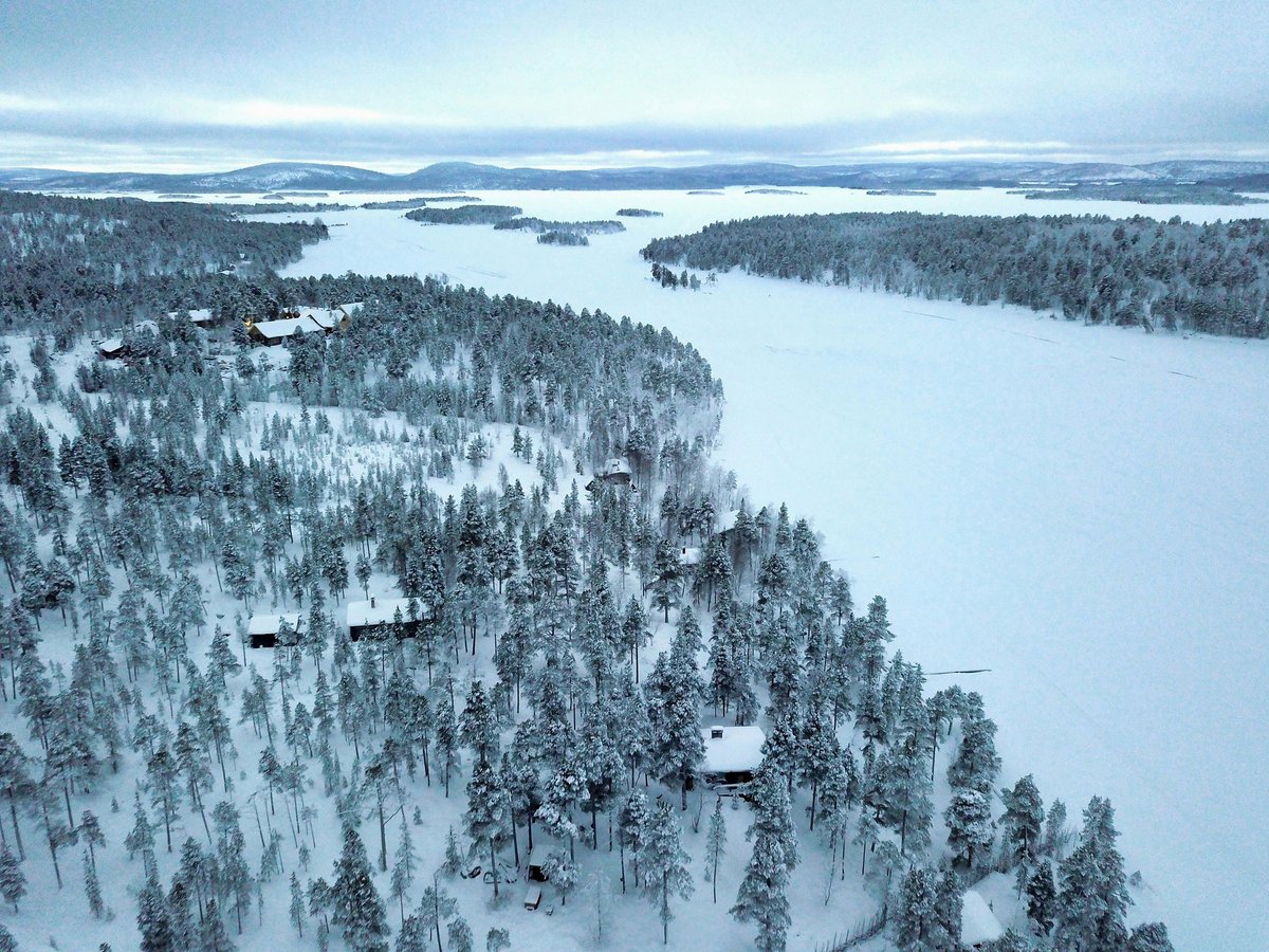 Snow-covered fells and forest above a frozen lake in northern Finland