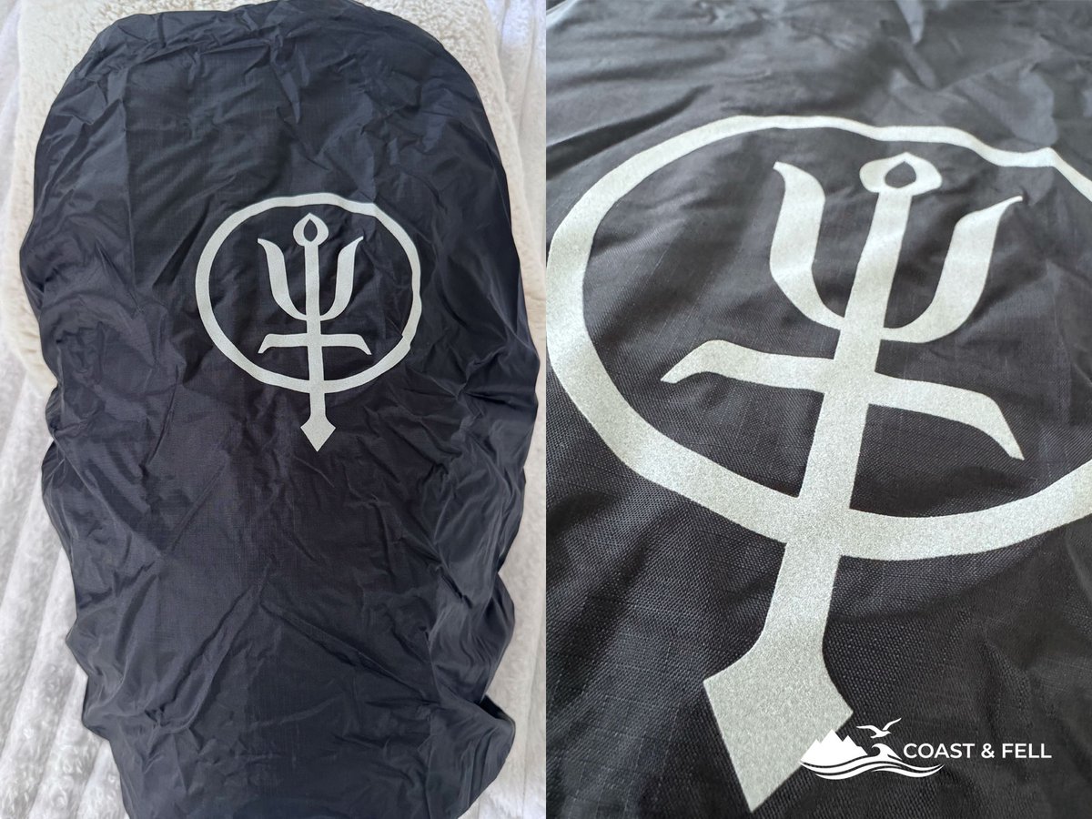 The Pinnacle 28's included rain cover deployed, with the reflective ThruDark trident logo for low-light visibility