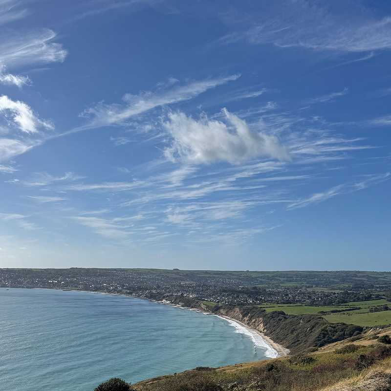 Swanage bay from the Ballard Down coast path, the beach and town curving round the water
