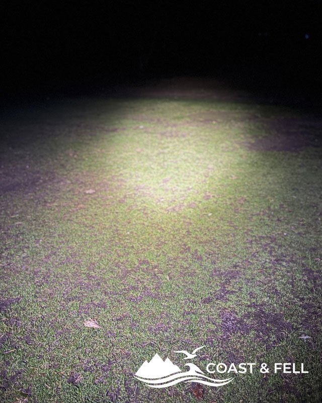 Meayll chest light beam spread across dark grass at night