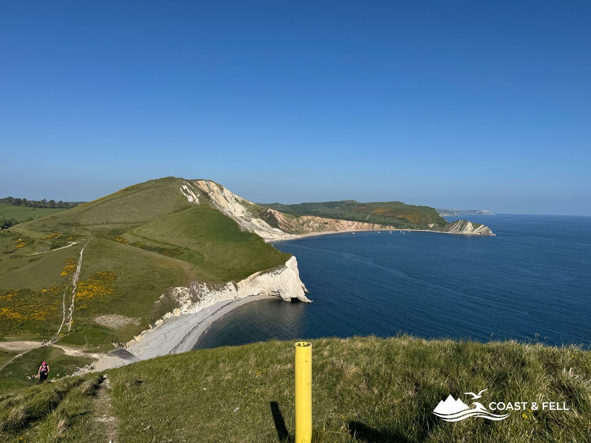Wide angle Mupe Bay and chalk headland with yellow event marker post